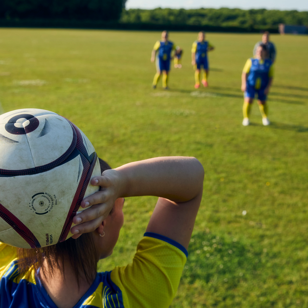 woman taking football free kick