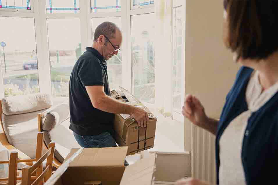 man and woman moving boxes