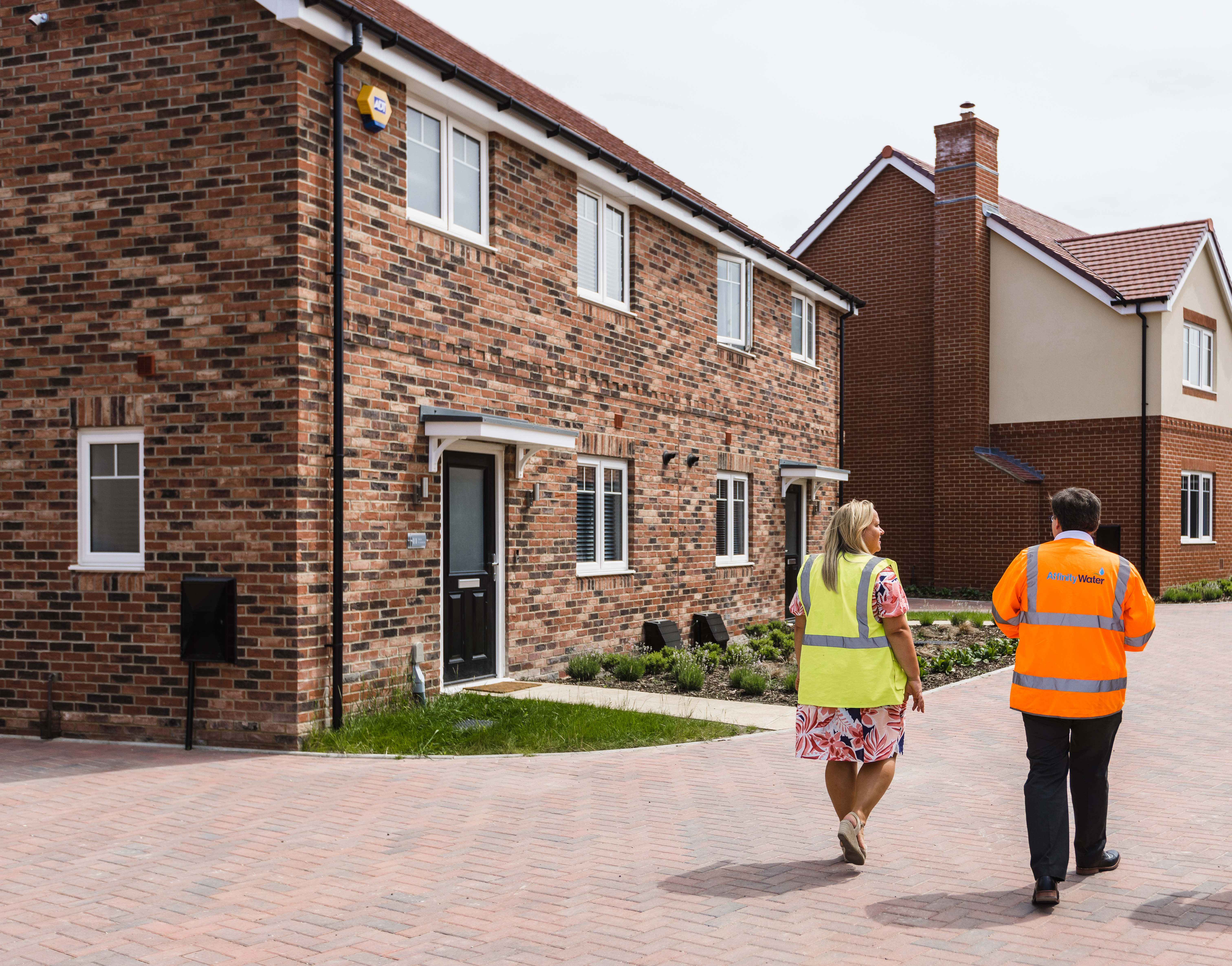 Man and lady walking through a new housing development