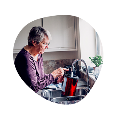 a woman filling a kettle