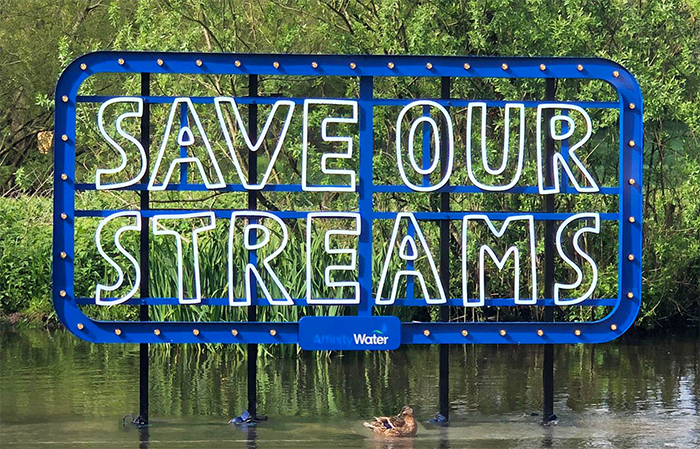 Save our streams sign in a stream