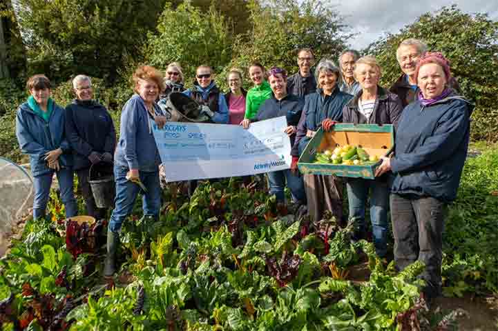 Members of FoodSmiles and Affinity Water employees holding up the cheque