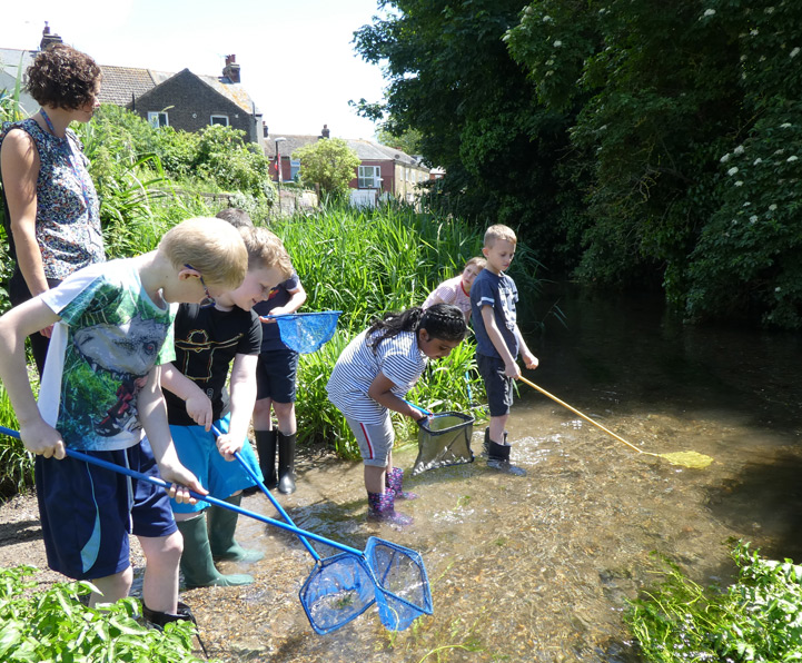Students river dipping along the River Dour