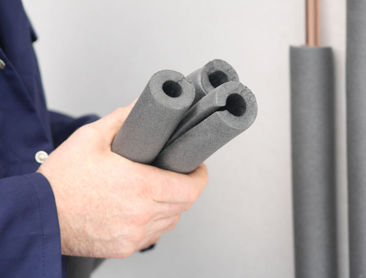 Image of a man holding pipe lagging